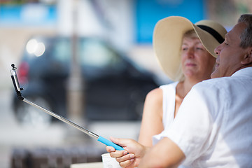 Image showing Middle-aged couple taking pictures with a phone