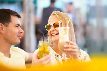 Image showing Happy couple drinking cocktails outdoor