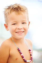 Image showing Young Blond Boy Wearing Beaded Necklace on Beach