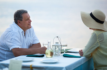 Image showing Middle-aged couple sitting waiting for a meal