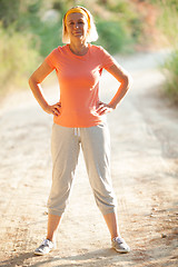 Image showing Mature Woman Standing with Hands on Hips on Road