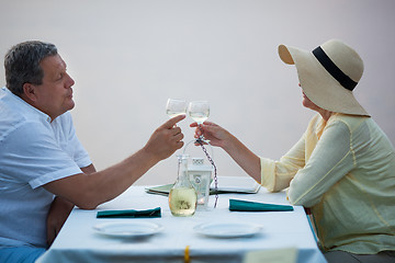 Image showing Romantic middle-aged couple toasting each other