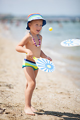 Image showing Young Boy Playing Paddle Ball on Sunny Beach