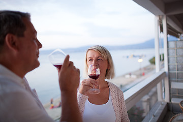 Image showing Couple Drinking Red Wine on Balcony of Beach Hotel