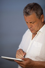 Image showing Man Using Pen on Handheld Tablet Computer