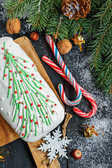 Image showing Cupcake with Christmas decorations, candies and spruce branches.