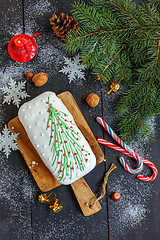Image showing Christmas cake, candy, snowflakes and a burning candle.