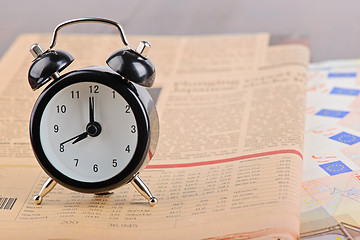 Image showing Close-up of clock, Euro banknotes and newspaper