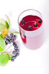 Image showing Glass of aronia juice with berries, overhead view