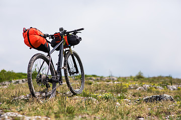 Image showing Bicycle with orange bags for travel