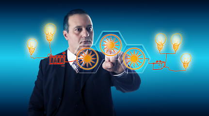 Image showing Smart Businessman Activating Solar Energy Buttons