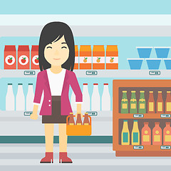 Image showing Woman with pack of beer at supermarket.