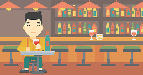 Image showing Man drinking wine at restaurant.