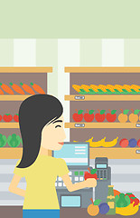 Image showing Cashier standing at the checkout in supermarket.