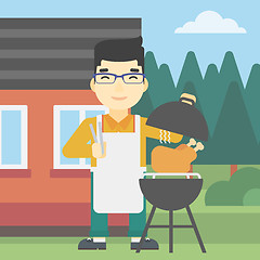 Image showing Man cooking chicken on barbecue grill.