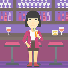 Image showing Woman drinking orange cocktail at the bar.