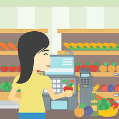 Image showing Cashier standing at the checkout in supermarket.