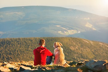 Image showing Man with dog on the trip in the mountains