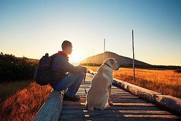 Image showing Man with dog on the trip in the mountains 