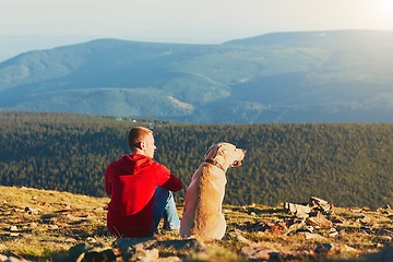 Image showing Man with dog on the trip in the mountains