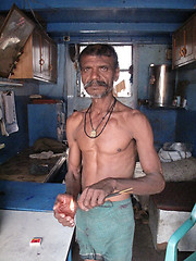 Image showing Streets of Kolkata. Hindu prayer, Man burns joss sticks