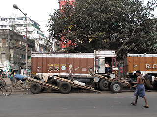 Image showing Streets of Kolkata. Trucks and carts wait for customers to transport their cargo