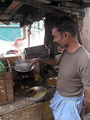 Image showing Man cooking on the street in the Chowringhee area of Kolkata, West Bengal, India