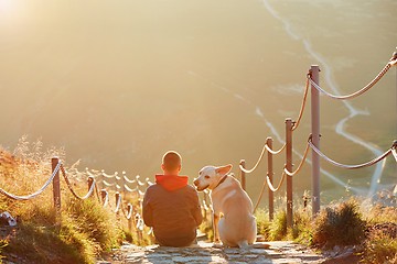 Image showing Man with dog on the trip in the mountains