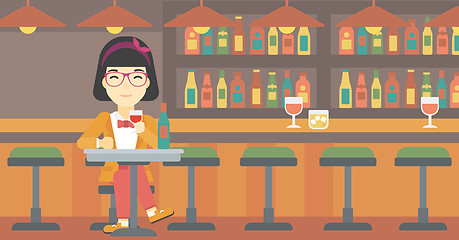 Image showing Woman drinking wine at restaurant.