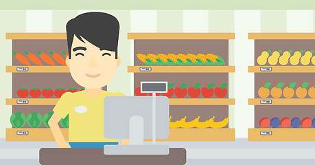 Image showing Cashier standing at the checkout in supermarket.