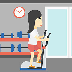 Image showing Woman exercising on elliptical trainer.