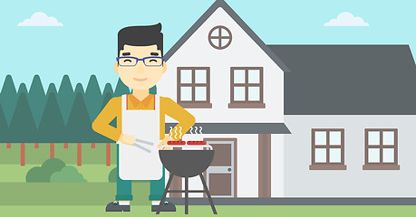 Image showing Man cooking meat on barbecue grill.