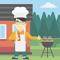 Image showing Man cooking meat on gas barbecue grill.