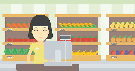 Image showing Cashier standing at the checkout in supermarket.