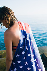 Image showing Back view of wet-haired woman in american flag