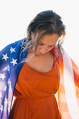 Image showing Smiling woman with wet hair and american flag