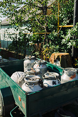 Image showing Trailer with cans full of rustic fresh milk