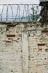 Image showing Brick wall with barbed-wire