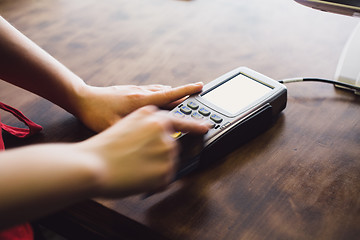 Image showing Female hand inserts the credit card into the terminal