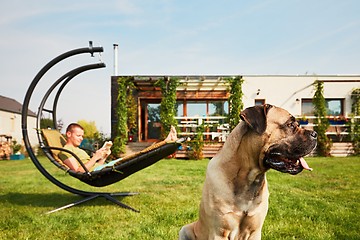 Image showing Man with dog on the garden