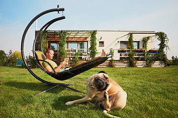 Image showing Man with dog on the garden