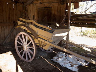 Image showing old wooden cart standing in one old barn
