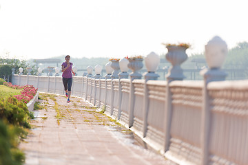 Image showing sporty woman jogging