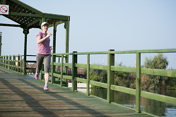 Image showing sporty woman jogging