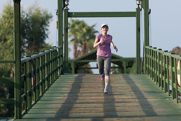 Image showing sporty woman jogging