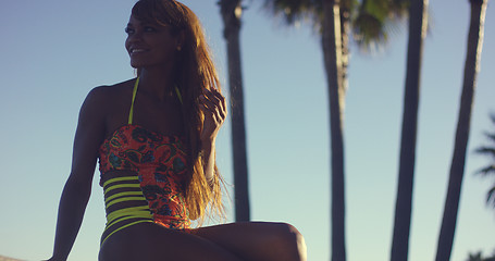 Image showing Sexy Woman Wearing Swimsuit Sitting on Bench