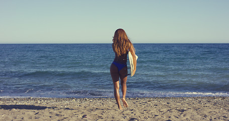 Image showing Sexy Woman with Surfing Board Walking at the Beach