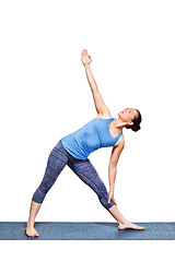 Image showing Woman doing yoga asana utthita trikonasana - extended triangle pose