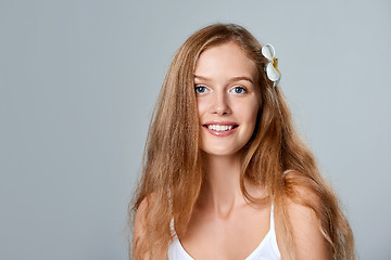 Image showing Beautiful young woman with flower in hair