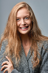 Image showing Happy laughing woman in warm knitted cardigan